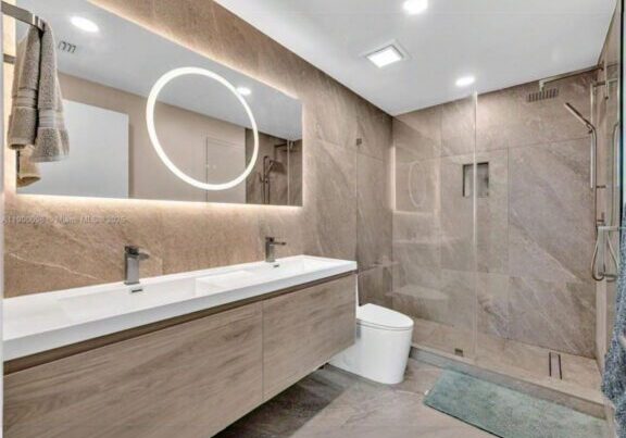 Modern bathroom with sleek design and warm lighting.